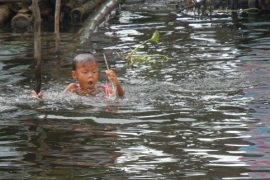 cambodia boy in the river