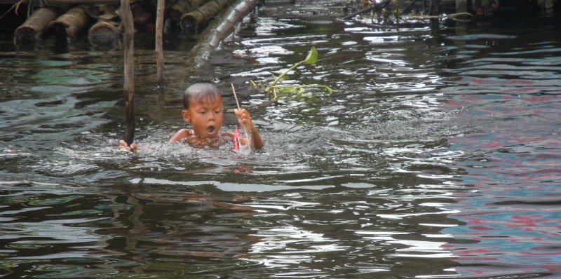 cambodia boy in the river
